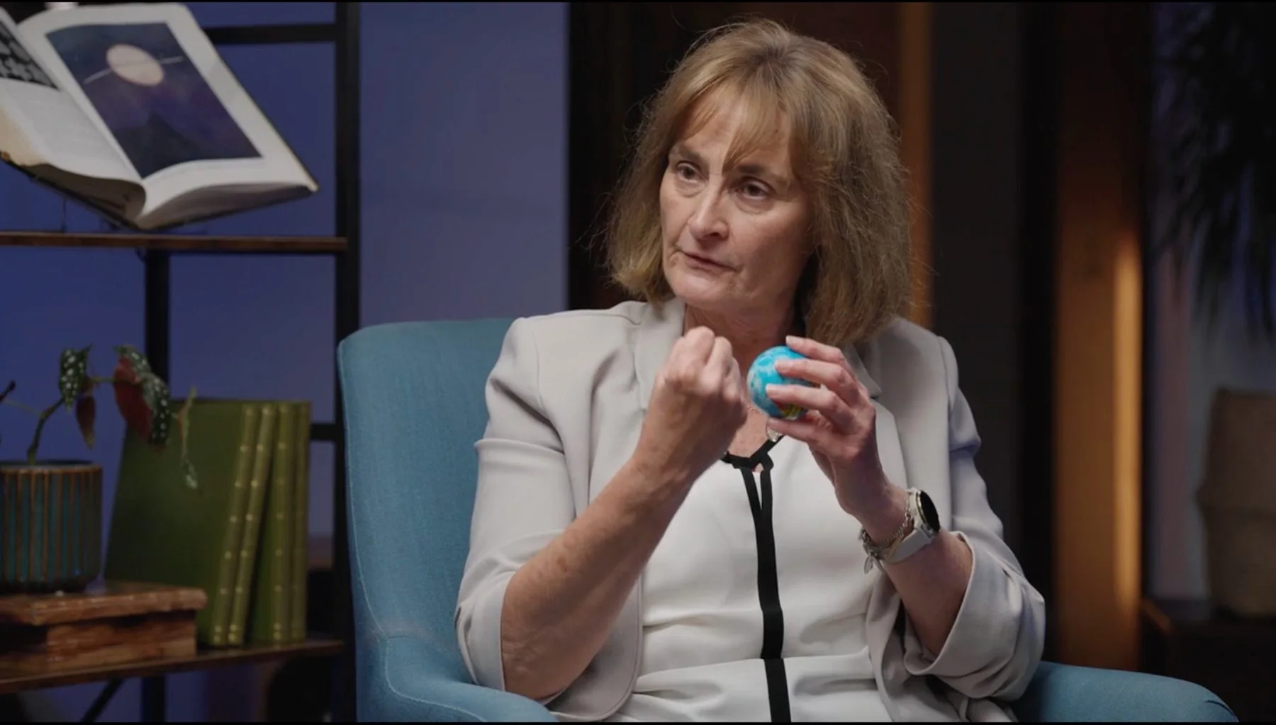 Interview contributor explaining a model globe